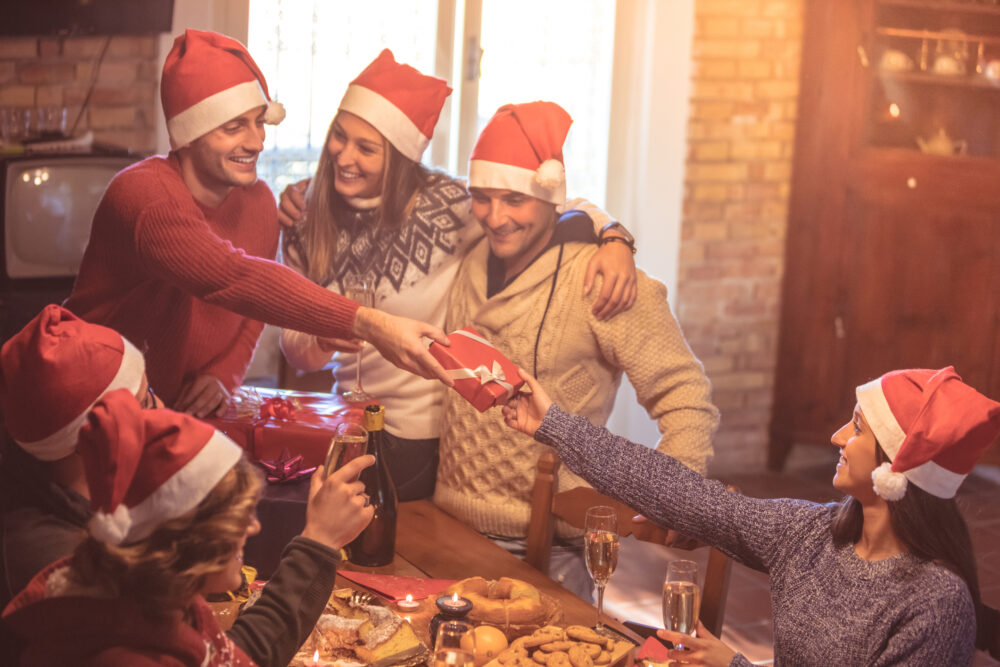 Friends giving holiday gifts